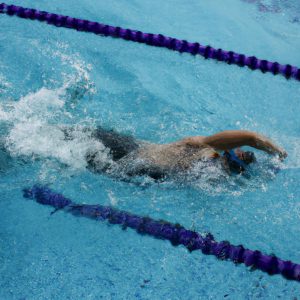 Person swimming breaststroke in pool