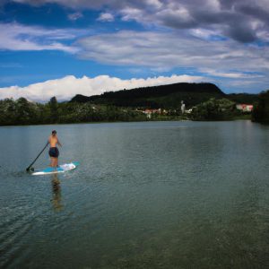 Person paddleboarding in scenic location